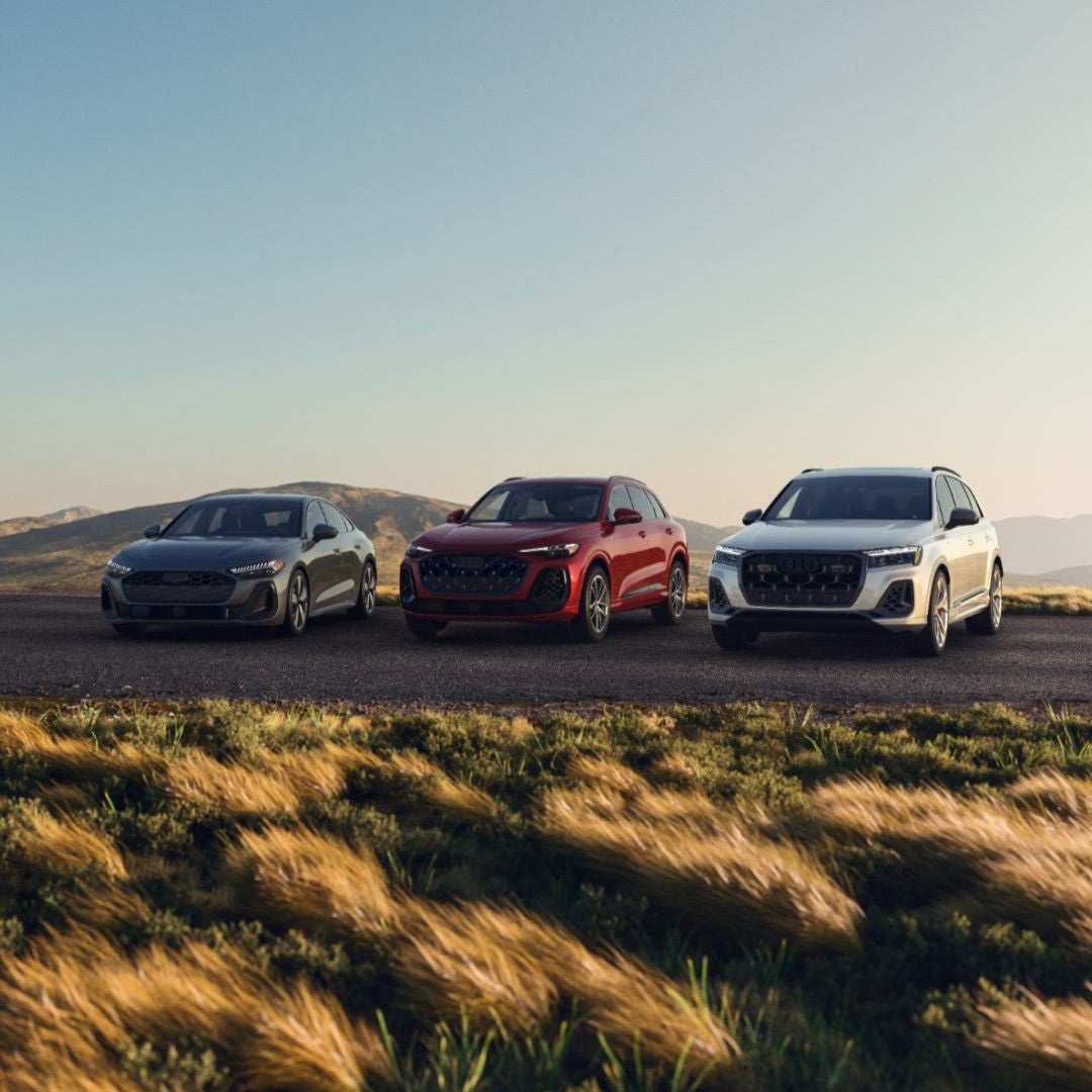 Three Audi vehicles in a lineup.